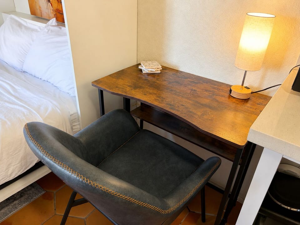 Get some focused work done at this laptop friendly workstation complete with a touch activated lamp that has an outlet for charging devices at night or powering your laptop during the day.