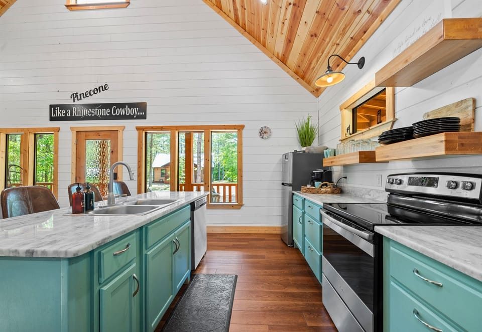Whip up a delicious meal in this fully equipped kitchen. The turquoise cabinets add a pop of color to the rustic decor.