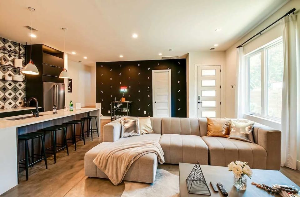 The bar cart anchors this living space while you watch the kitchen island from the sectional, creating sight lines perfect for groups who like to stay connected