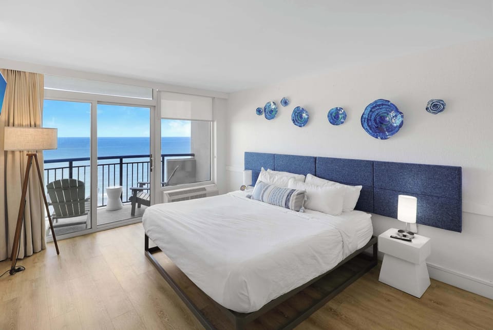 Enjoy a great night's sleep in this bedroom, featuring a plush king-size bed, modern decor, and plenty of natural light.