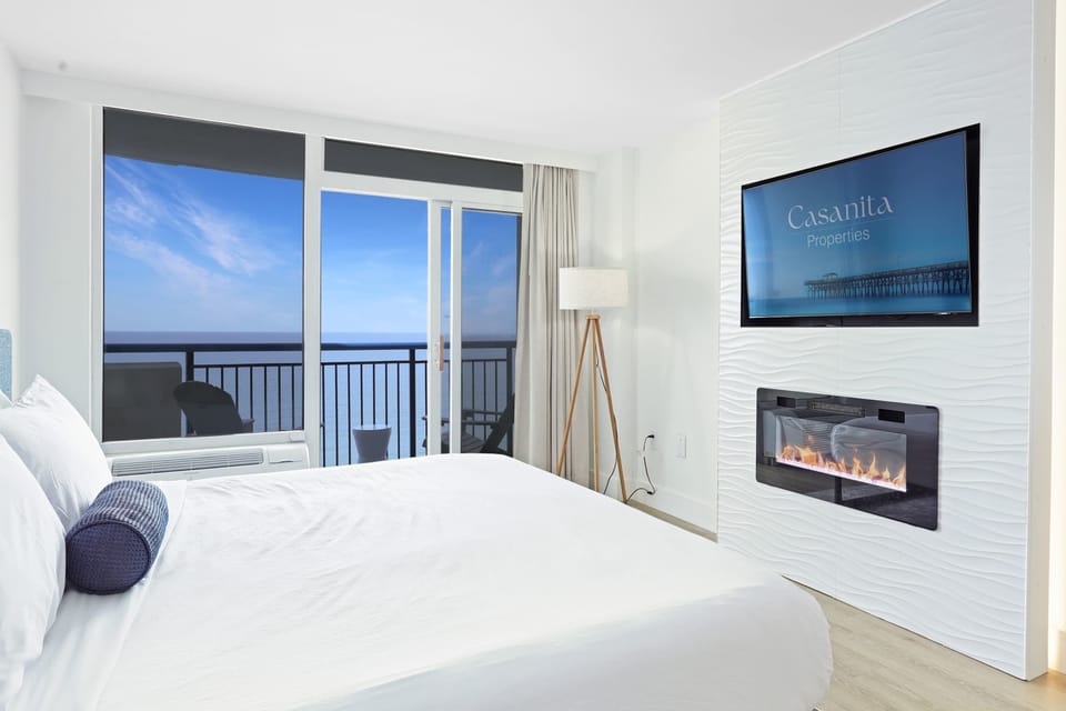 Spacious guest bedroom featuring a King-sized bed, plush linens, and a smart TV for winding down in comfort.