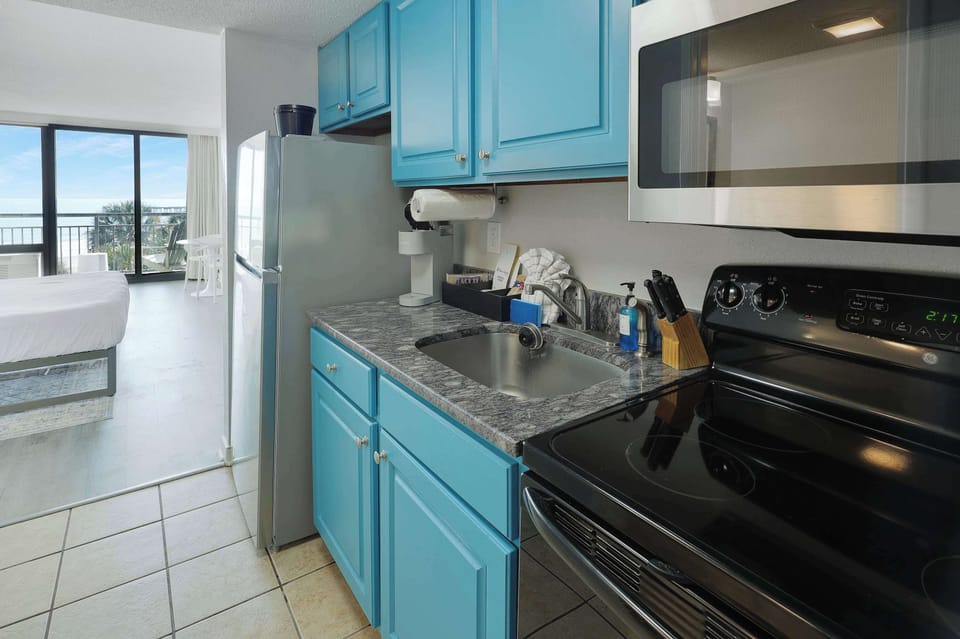 Enjoy the convenience of a full kitchen with everything you need to cook up your favorites. With ocean views just steps away, this space makes dining in as delightful as heading out. Perfect for extended stays or cozy beachside meals.