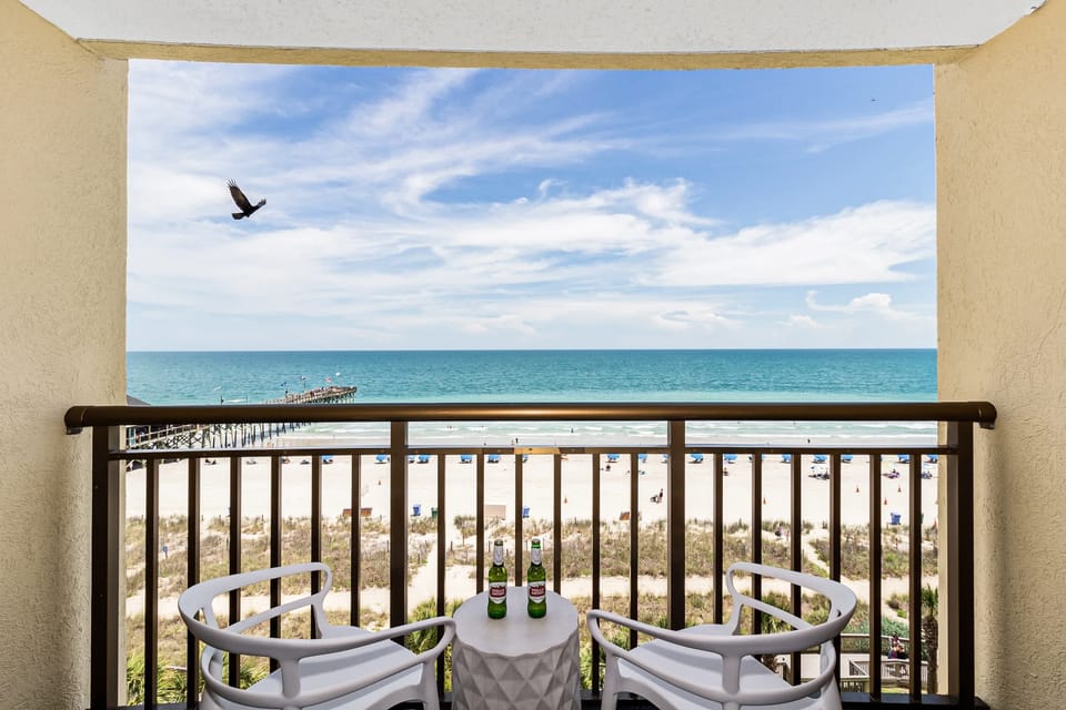 Enjoy stunning ocean views from your private balcony, complete with cozy seating to relax and take in the sights of the beach. Perfect for morning coffee or sunset evenings!