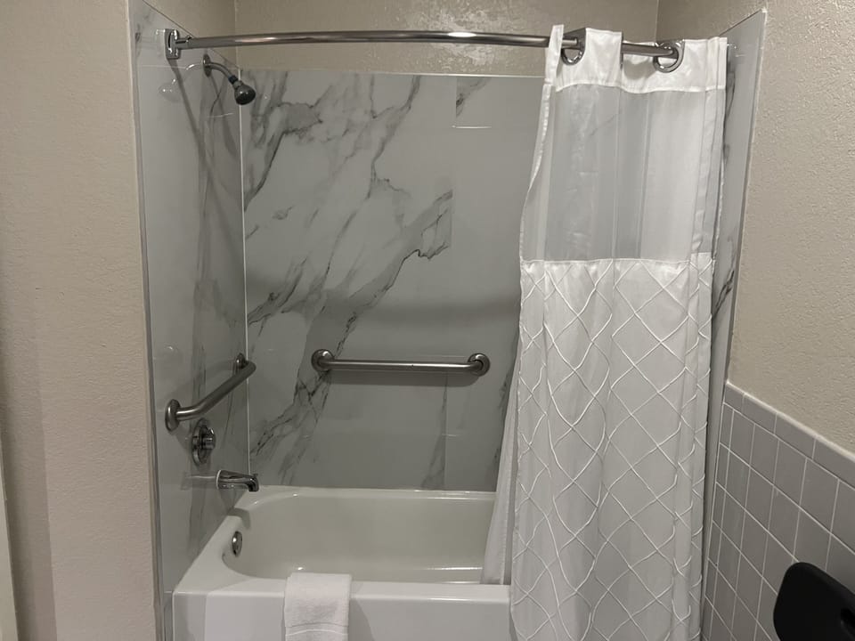 2 QUEEN NON SMOKING- DISABILITY ACCESS | Bathroom | Bathtub, hair dryer (on request), towels, soap