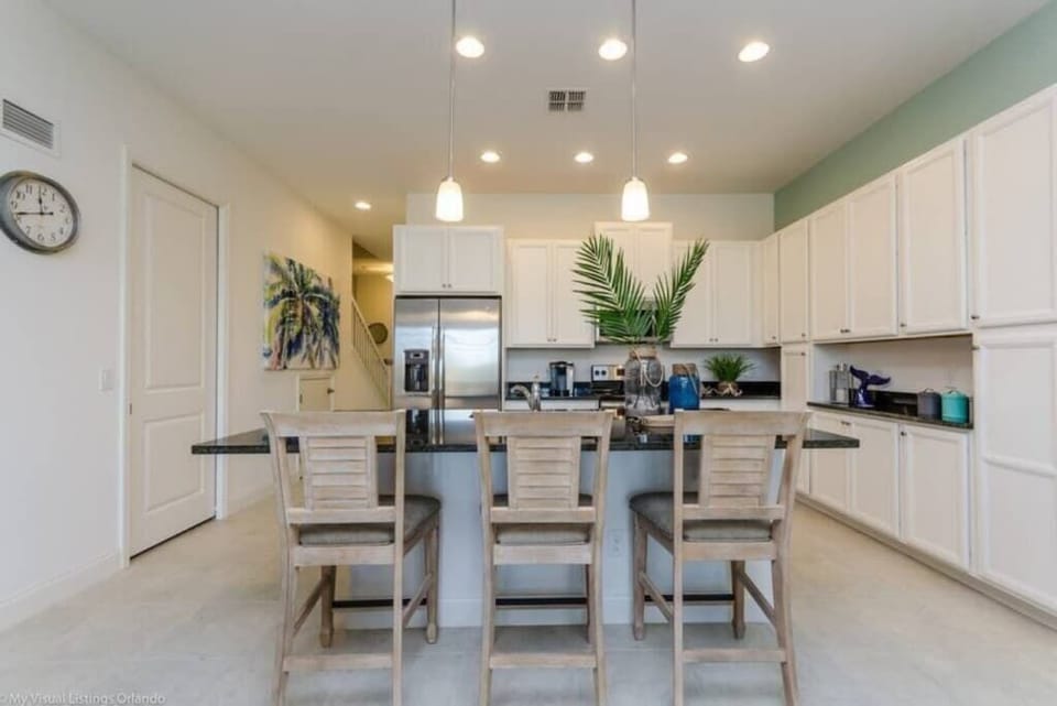 - Modern kitchen with island seating stainless appliances and open flow
- Fully equipped kitchen perfect for cooking meals during your stay
- Myrtle Beach condo kitchen with bar stools and dining space nearby  