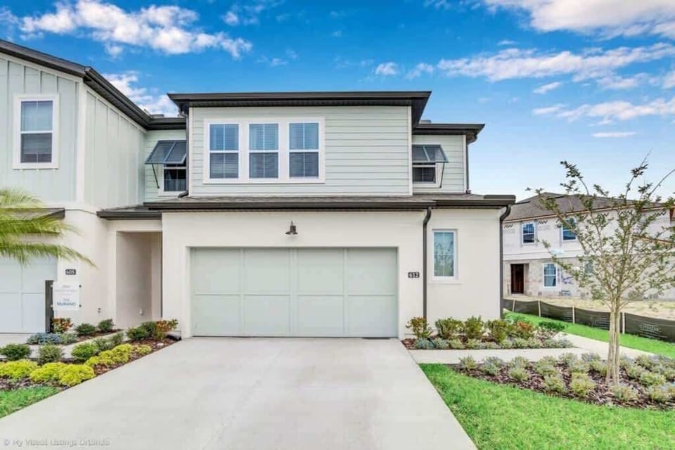 - Modern townhouse exterior with private driveway, garage, and entry  
- Quiet neighborhood setting close to resort amenities and main roads  
- Well kept home frontage with landscaping and easy arrival access  