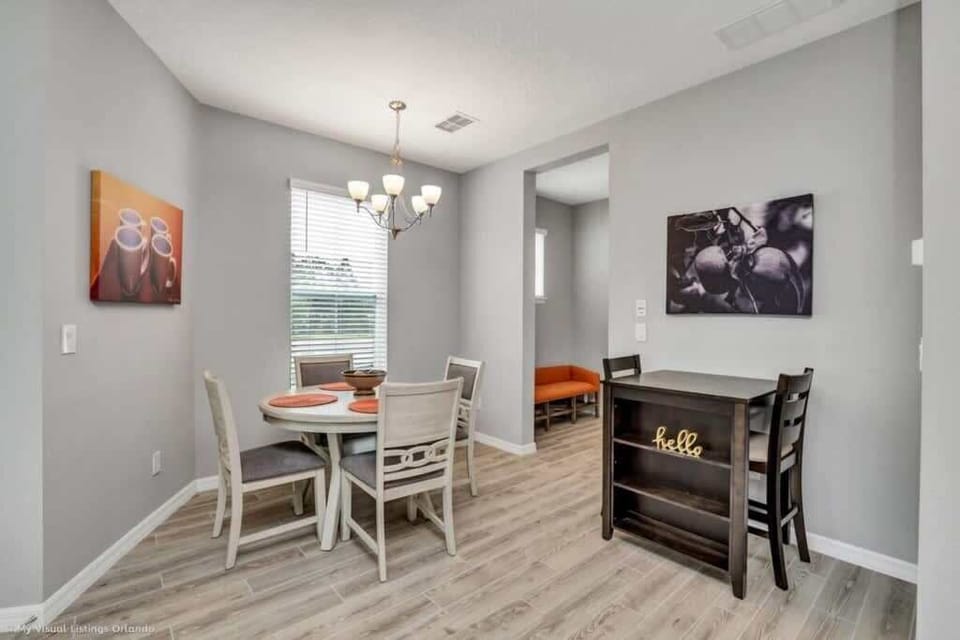 - Dining area with table seating, open layout, and modern flooring  
- Bright space for meals, work, or evening conversations  
- Simple functional design connecting kitchen and living areas 