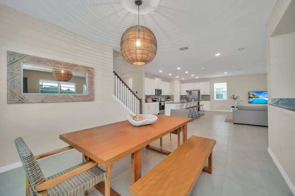 - Dining area with large table open kitchen view and modern lighting
- Perfect spot for shared meals games and long conversations
- Open flow connects dining kitchen and living areas easily  