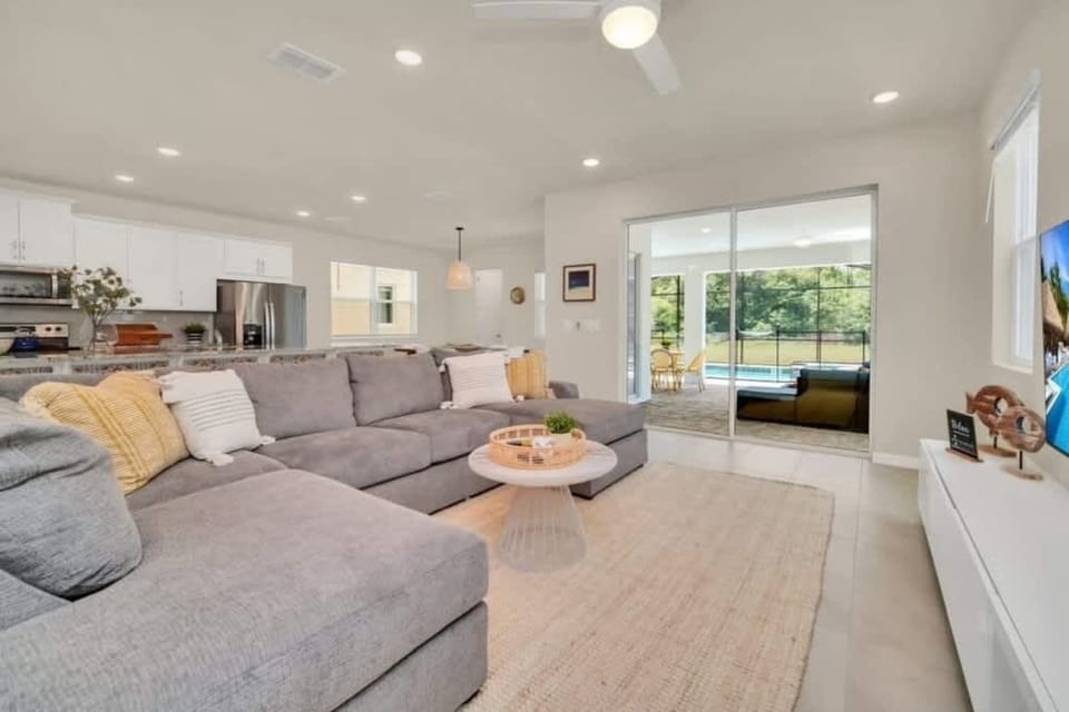 - Main living area with sectional and open kitchen
- Easy flow to dining patio and entertainment
- Ideal space for groups to relax and connect
