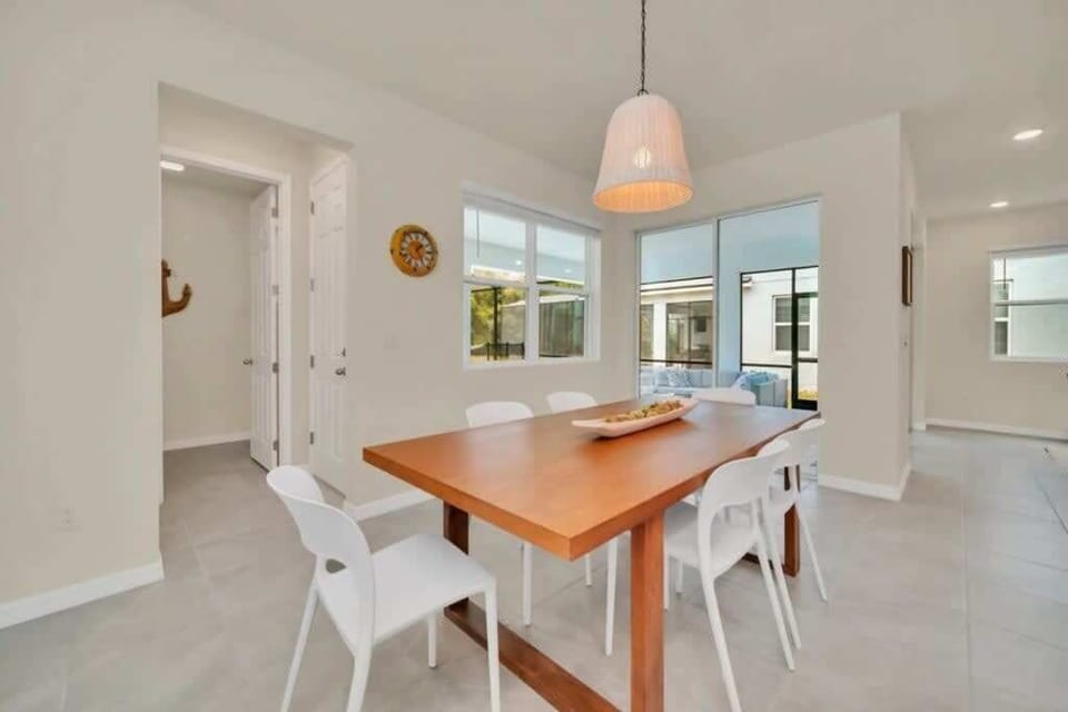 - Dining area with table near kitchen and patio
- Bright windows for morning meals together
- Easy flow space for family dinners and games
