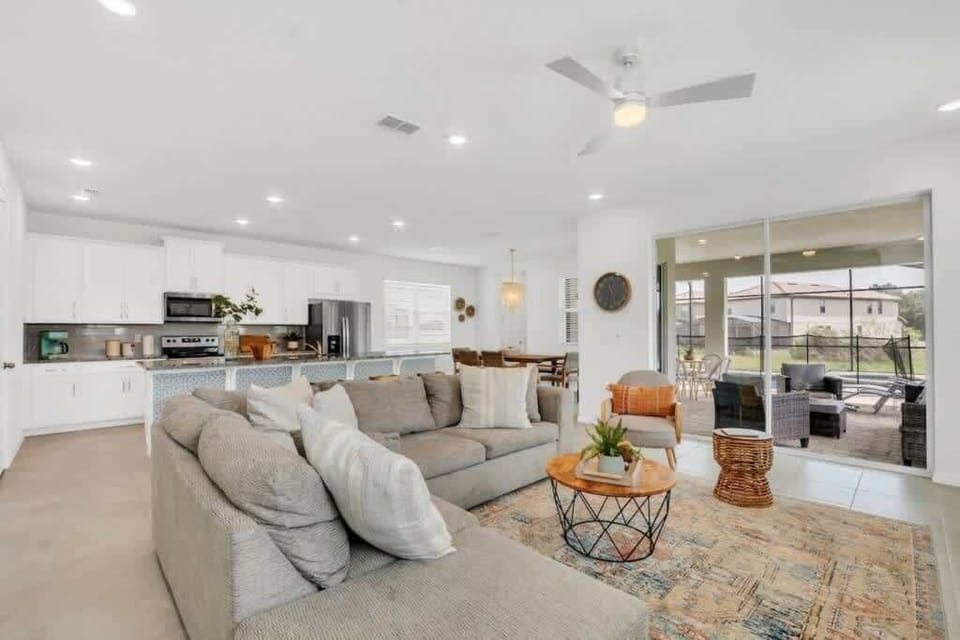 - Open concept living room with sectional sofa and natural light
- Spacious lounge near kitchen perfect for group gatherings
- Comfortable home living area with seating flow and calm style