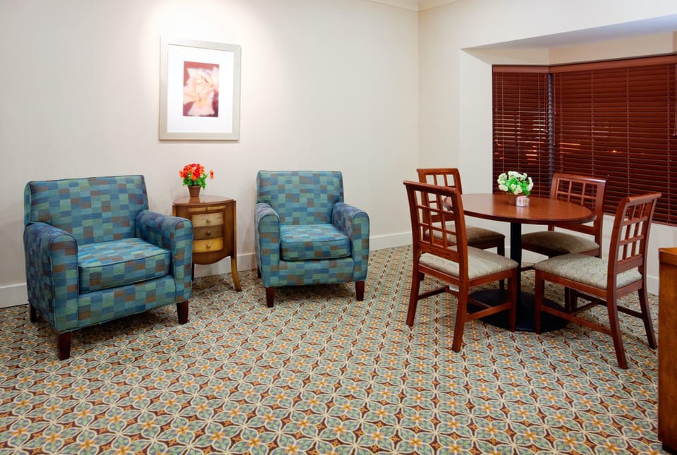 Relax in stylish comfort—plush armchairs and a cozy dining space await your arrival.