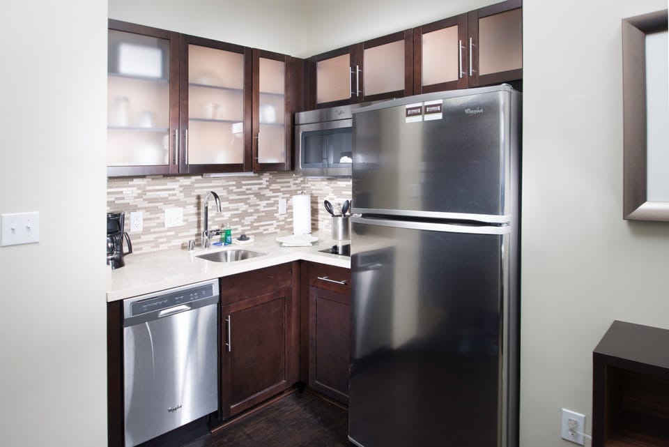 Kitchen with stainless steel appliances and full cabinetry.