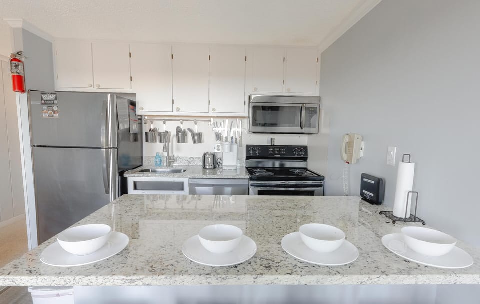 Enjoy a sleek, contemporary kitchen complete with granite countertops and stainless-steel appliances.