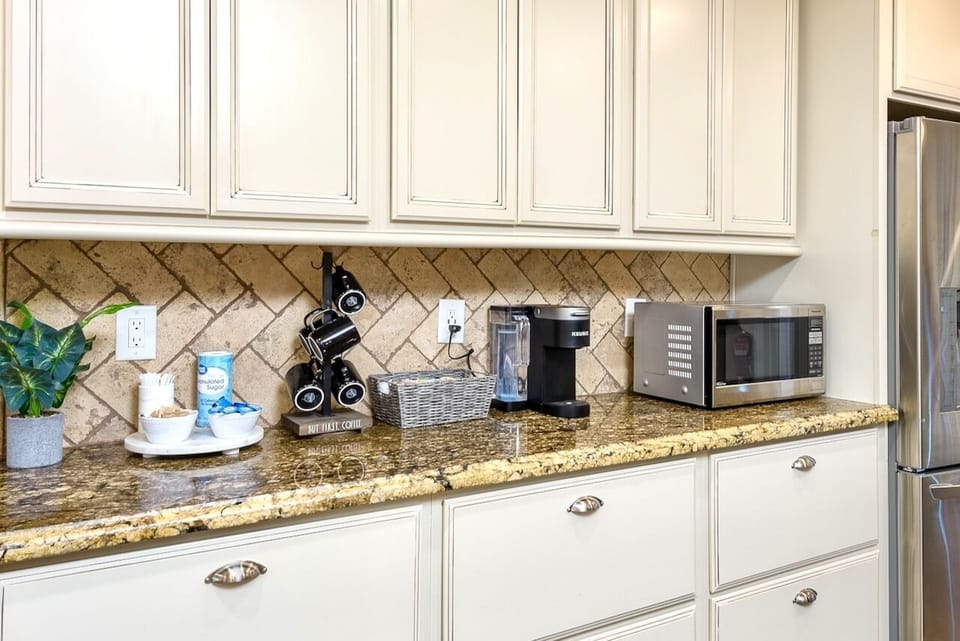 Stocked coffee bar with Keurig coffee maker, coffee pods, cream, and sugar