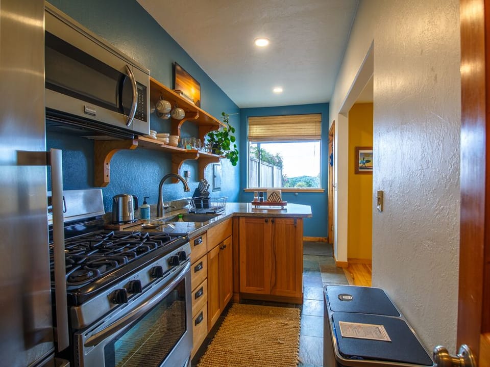 Kitchen has a window out to garden and distant ocean view on a clear day.