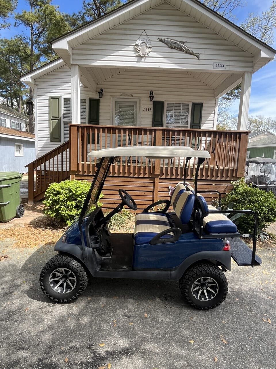 Welcome to the front of the cottage—complete with a fun-filled golf cart available for rent during your stay!