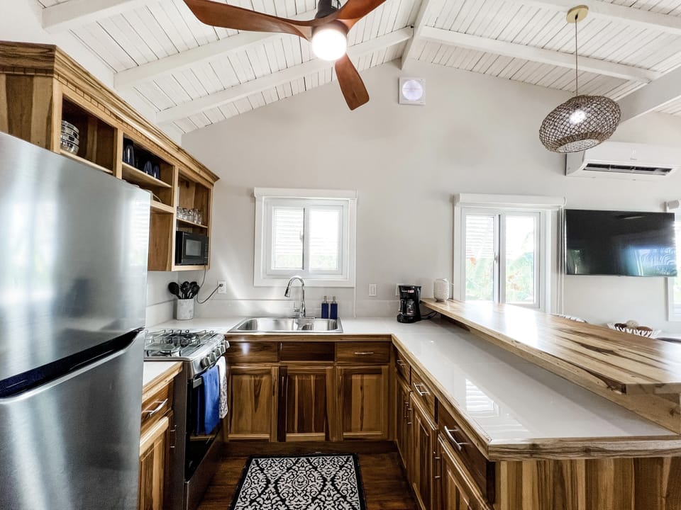 Full-sized kitchen designed with local wood and stainless steel appliances.