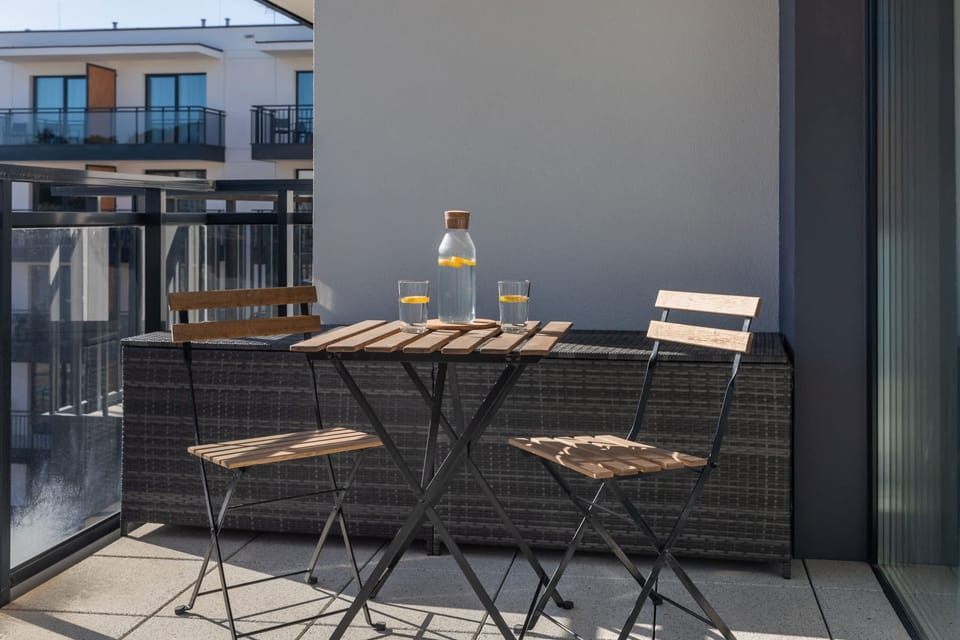 Another perspective of the terrace, featuring a small café-style table set for two, ideal for enjoying coffee outdoors.
