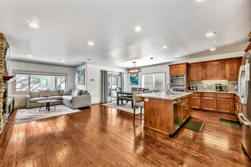 Your open-concept haven features gleaming hardwood floors, a gourmet kitchen island, and cozy living area perfect for memorable gatherings.