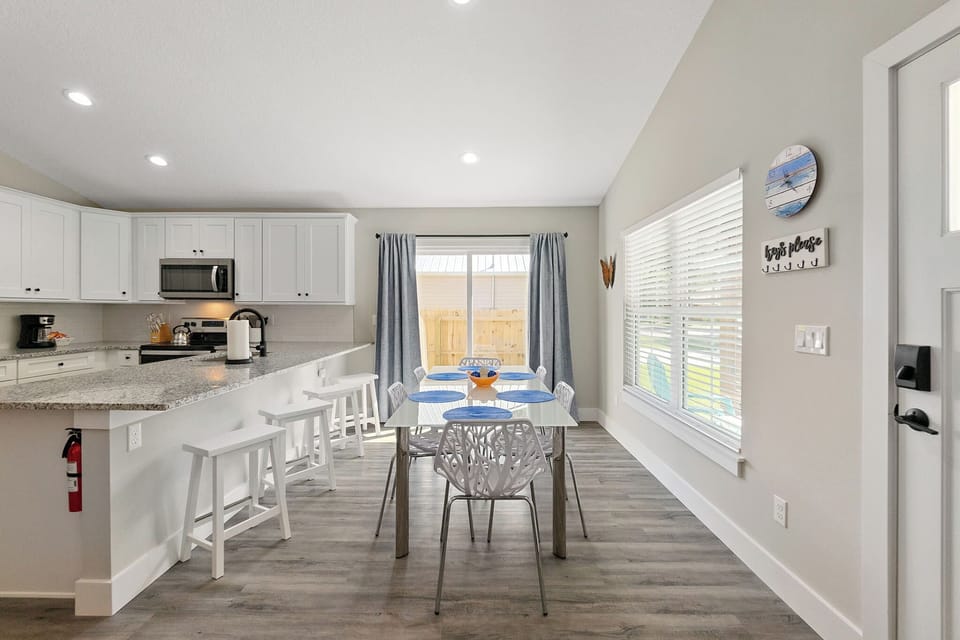 Eat together at the stylish dining table or up at the sleek breakfast bar