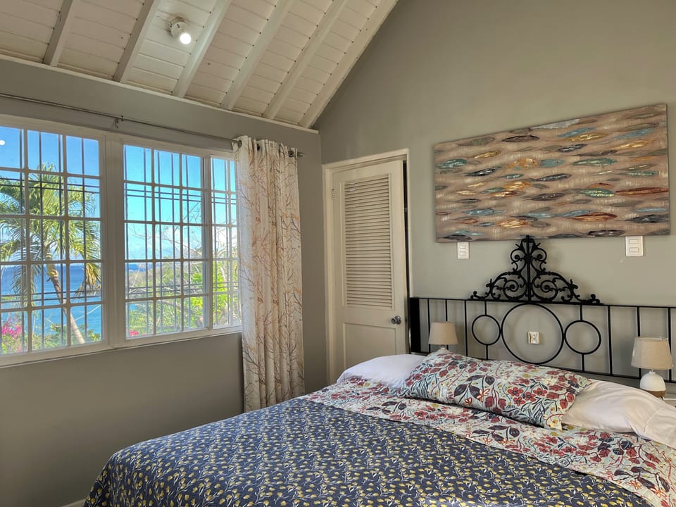 Primary Bedroom - King bed, private bath, sea  and garden view