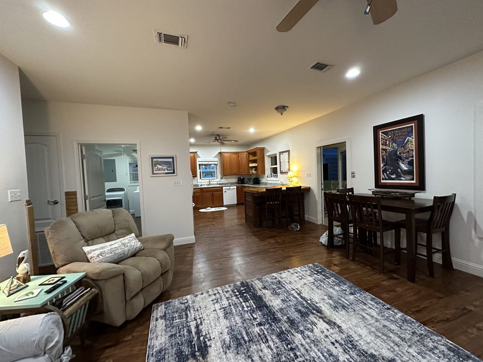 Open den with windows overlooking the back porch. 