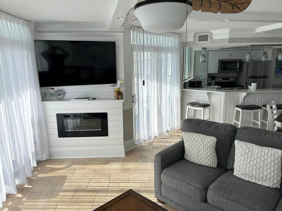 Enjoy the electric fireplace with TV after a day at the beach
