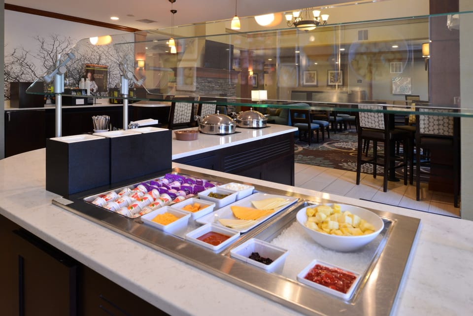 Breakfast buffet area with a variety of food options on display.