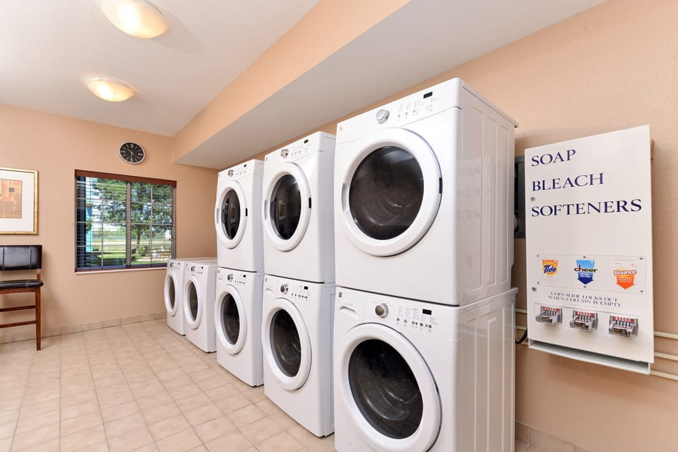 Guest laundry facility equipped with washing and drying machines.