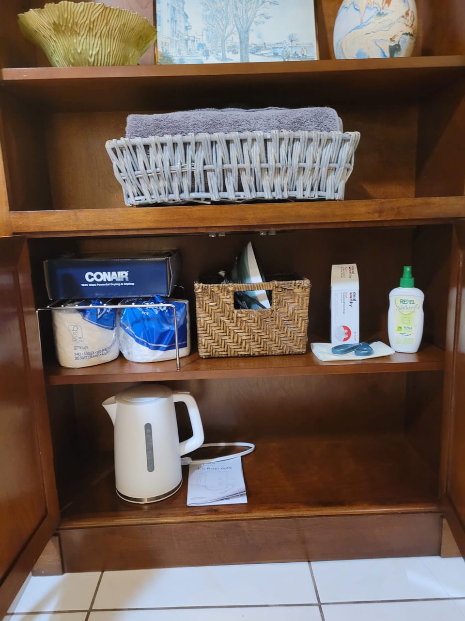 Iron, Tea Kettle, hair Dryer, trash bags, extra toilet paper, and scissors. 