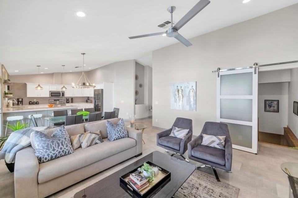 Open concept modern great room with a barn door access to the basement game room