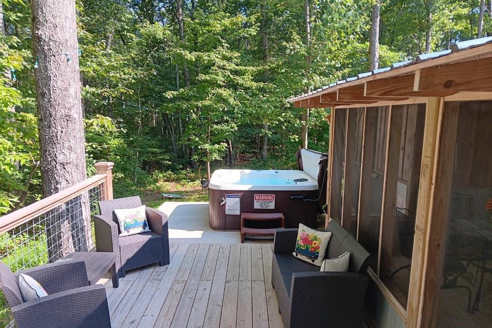 Screened in porch, deck and hot tub overlooking private view of the woods