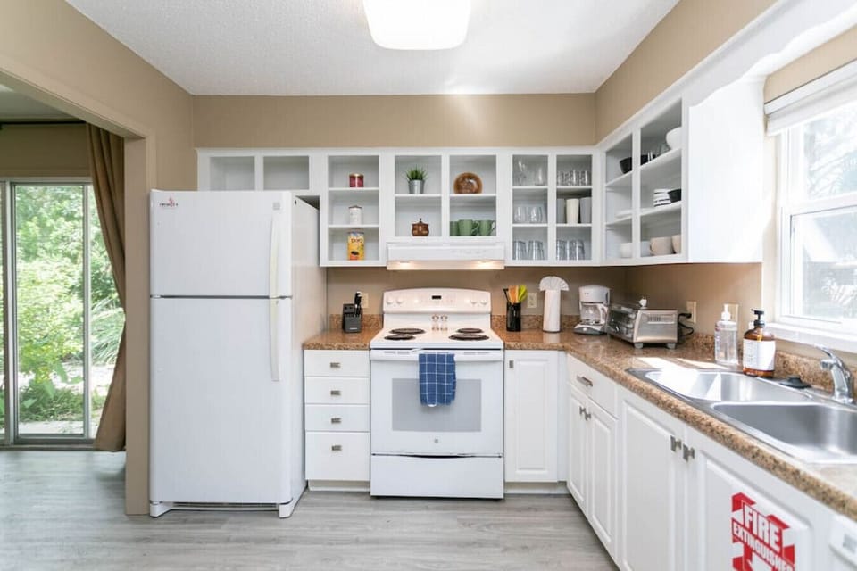 Pristine kitchen with lots of counterspace for food prep.