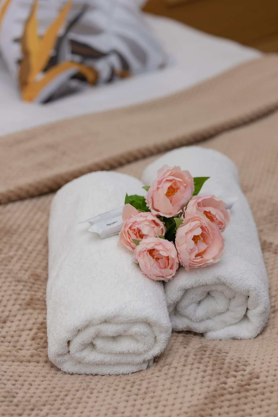 A close-up of soft towels decorated with small roses, adding a welcoming touch to the interior.
