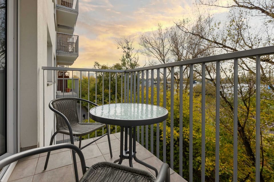 A private balcony with outdoor seating, ideal for enjoying sunsets and the surrounding greenery.
