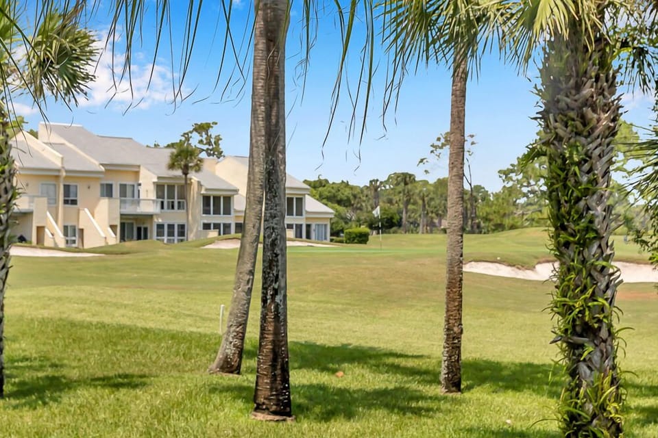 Enjoy scenic views of the manicured golf course through swaying palms right outside.
