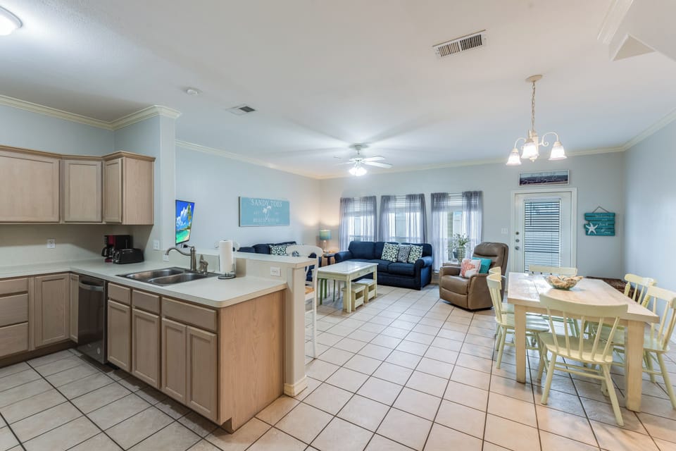 Unwind in your bright, open living space featuring a fully equipped kitchen, comfortable seating, and dining area perfect for family gatherings.