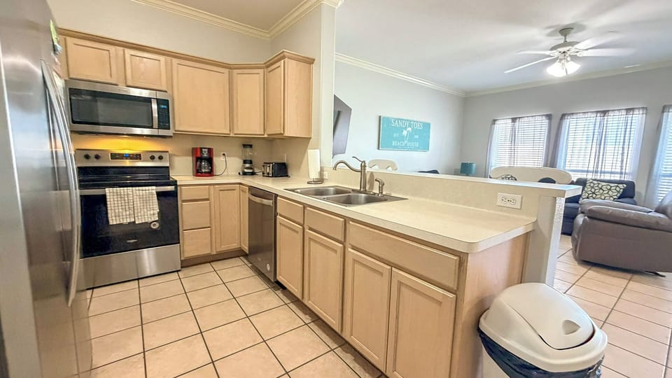 Your fully equipped kitchen features modern appliances and ample counter space for preparing meals during your beach getaway.