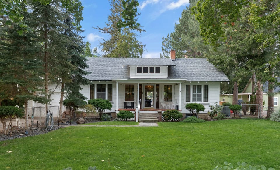 You will find a fully fenced front yard surrounded by peaceful towering pines.