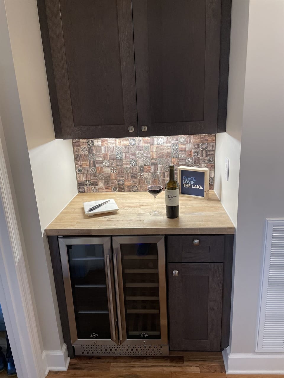 Newly added beverage center includes glasses, wine opener and other guest amenities.  Just off the kitchen and Mater Bedroom.