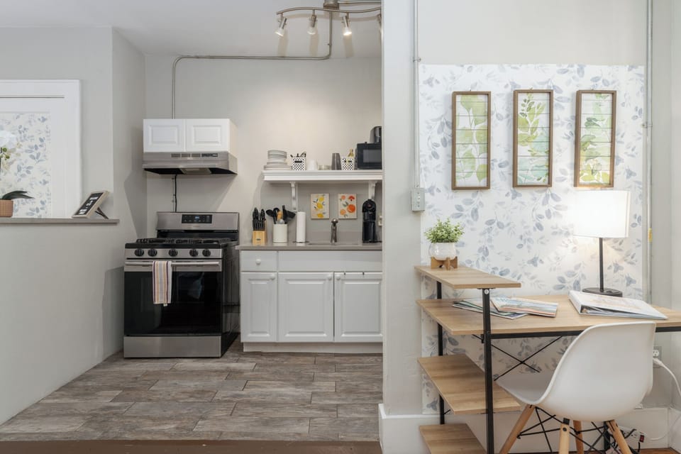 Where culinary creativity meets productivity: a spacious kitchen-office combo designed for seamless cooking and working.