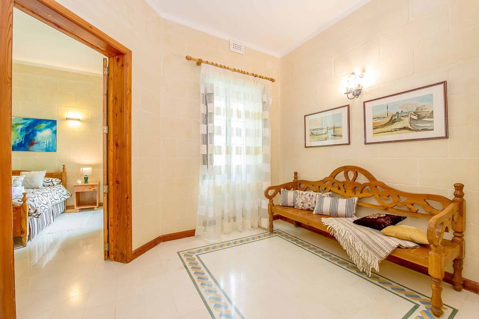 Bedroom and lounge area of Djar ta' Menzja 3 holiday home in Gozo