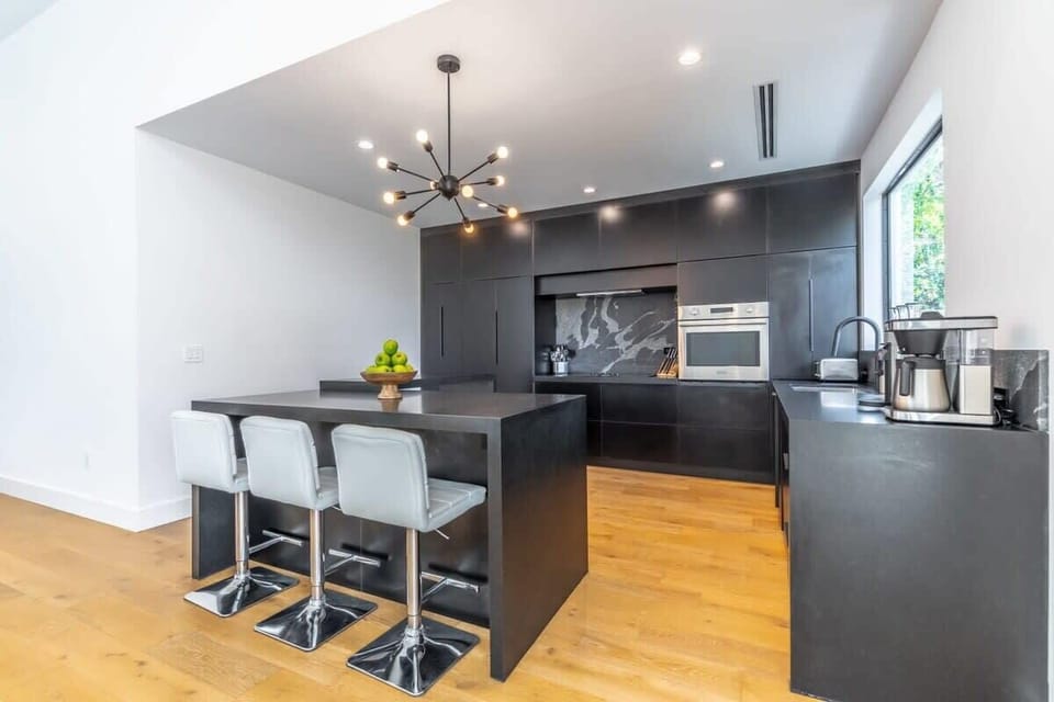Modern kitchen design with breakfast bar and essentials for coffee and cooking needs