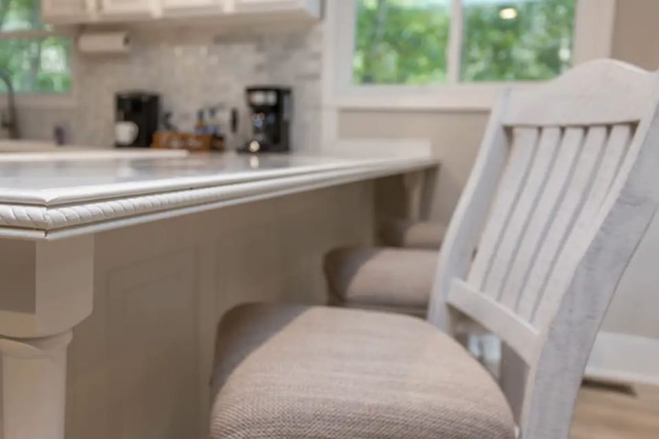 Three barstools sit just beside the table at  countertop to allow for 11 seats