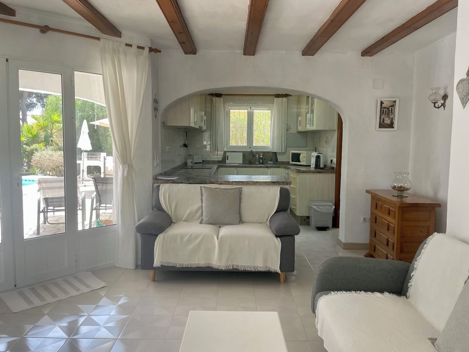 Lounge leading to kitchen and terrace