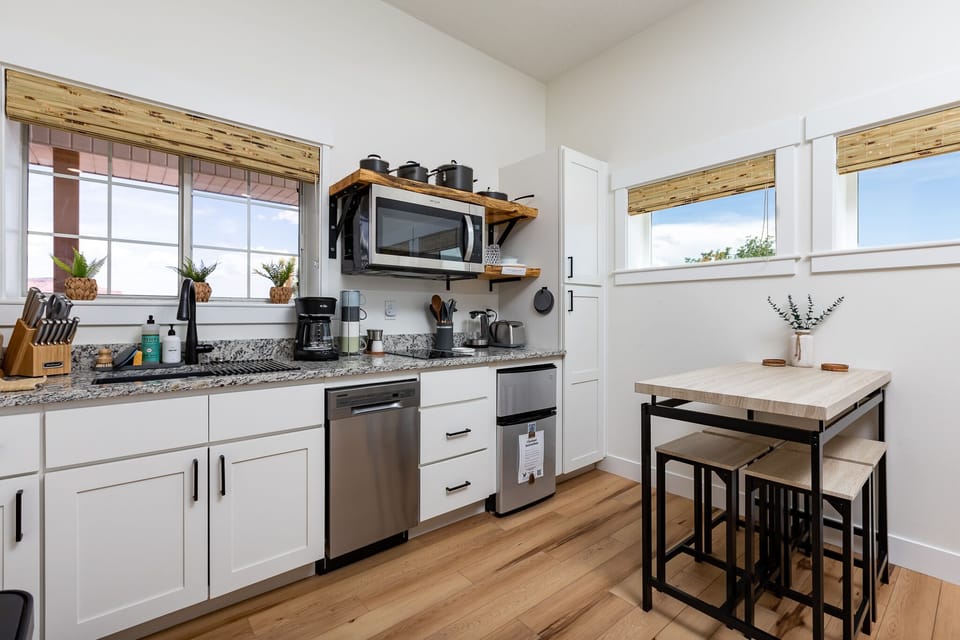 Kitchenette with electric cooktop, microwave, dishwasher and mini fridge