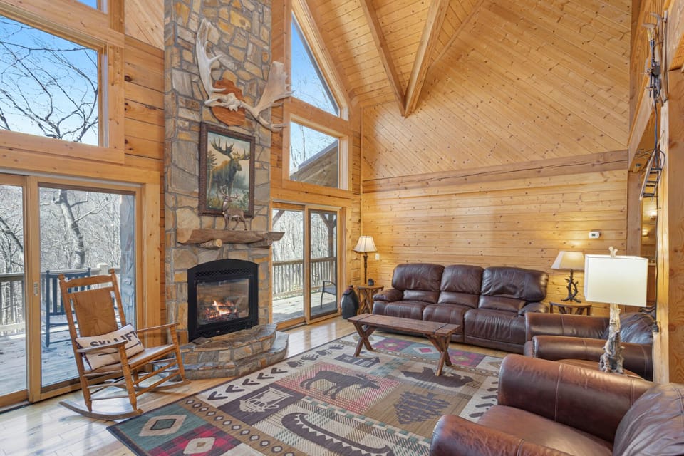 Great Room with Stacked Stone Fireplace Flanked by Windows