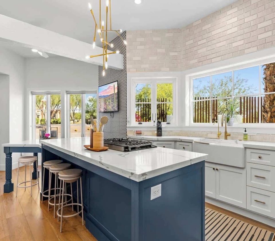 Modern kitchen with a large island and natural light from multiple windows