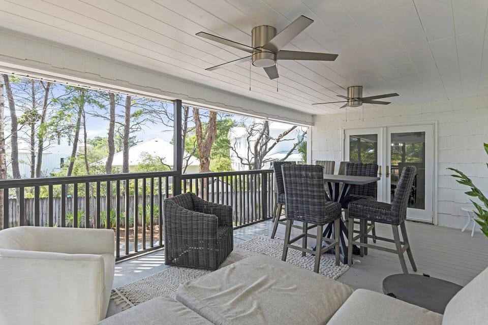Screened patio lounge offering breezy comfort and peaceful outdoor living.